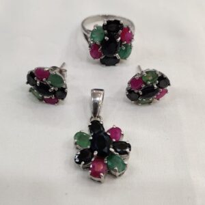 Gem stones jewelry set with silver ring, earrings, and pendant featuring green, pink, and black stones on white background