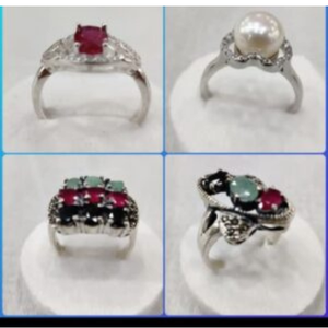 Four handcrafted engagement rings featuring red gemstones, pearls, and intricate silver band designs.