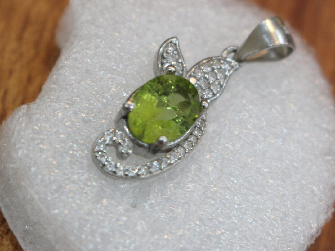 Handcrafted Peridot Pendant symbolizing emotional grounding and panic relief through ethical Afghan design