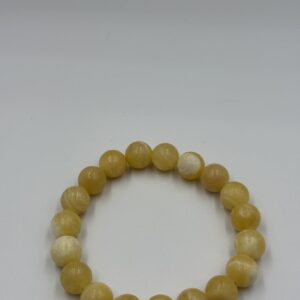 Carnelian agate stone bracelet with polished orange beads on an elastic cord