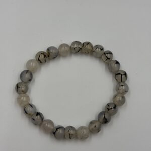 white Sulamini agate bracelet with 8mm polished beads on a silver-toned elastic cord.